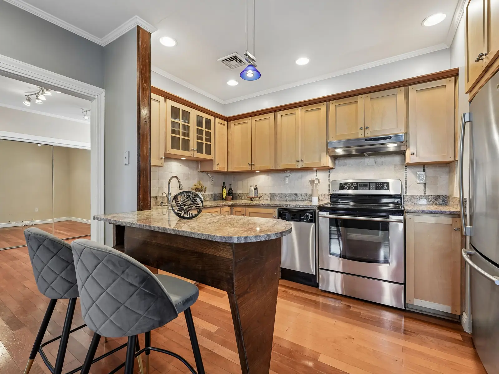Renovated kitchen with granite peninsula, maple cabinets, stainless steel appliances, and breakfast bar seating in Denville rental